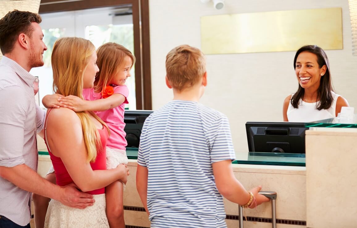 A family checks into a welcoming hotel in Port Wentworth, setting the stage for a comfortable stay near Savannah.